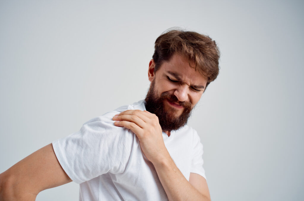 emotional man in a white t-shirt stress medicine pain in the neck isolated background